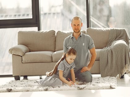 man-in-grey-polo-shirt-sitting-beside-girl-in-grey-checked